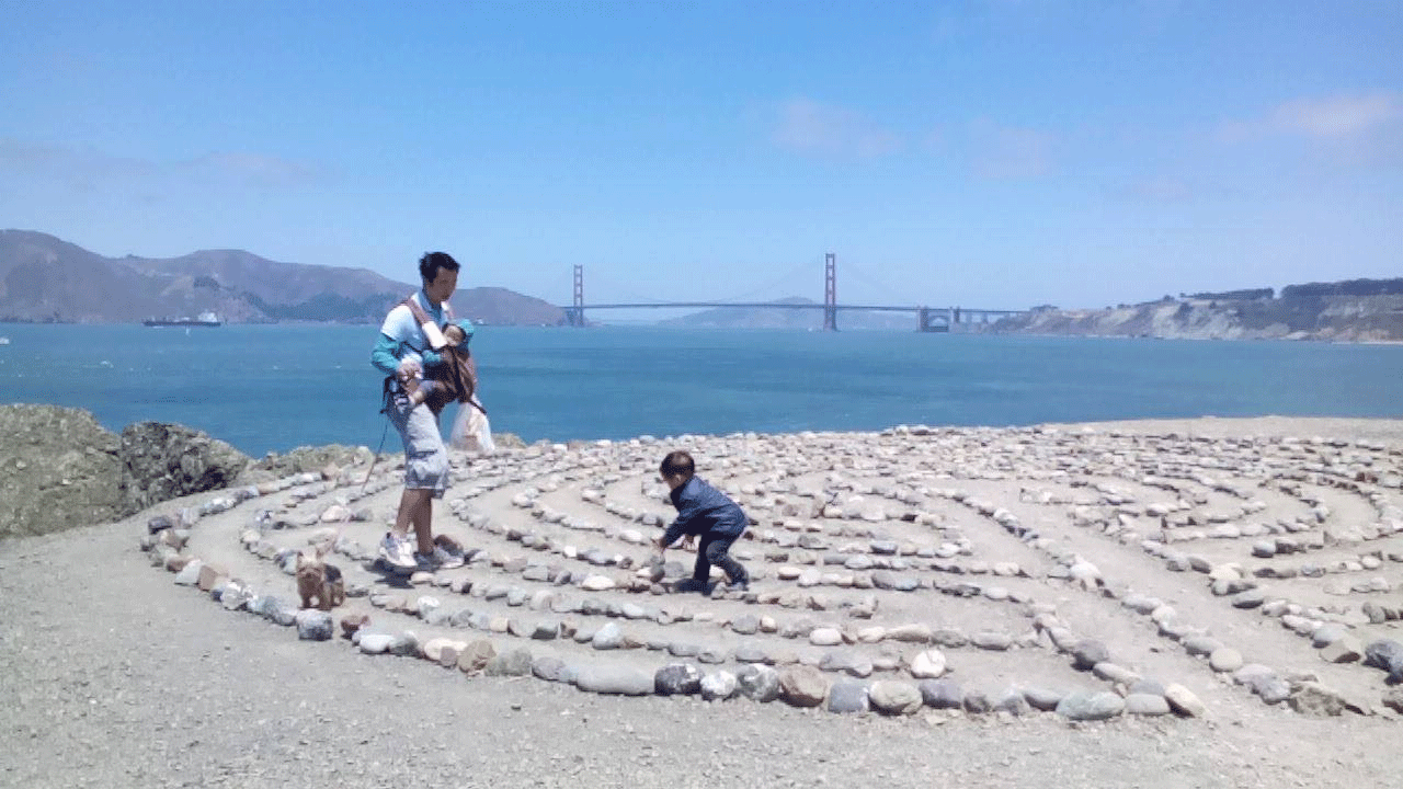 Picture of father and son walking an amazing maze by the ocean cliff